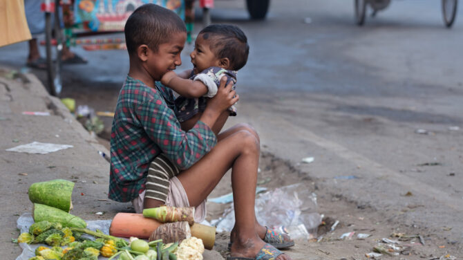 8-årige Parvez tryster sin lillebror, imens han forsøger at sælge grøntsager på gaden i Dhaka, Bangladesh. Foto Jannutul Mawa